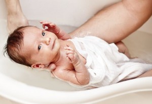 Os pais podem começar dando banho ainda nos primeiros dias ou meses de vida do bebê. Isso ajuda a estreitar os laços entre pai e filho em um momento em que a ligação do bebê com a mãe é muito forte. Foto: Getty Images