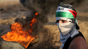 size_810_16_9_palestino-em-frente-a-pneus-em-chama-em-protesto-na-cisjordania