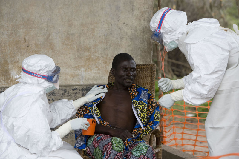 FILE -In this Saturday, Sept. 29, 2007, file photo, A 43 year old Congolese patient, center, who has been confirmed to have Ebola hemorrhagic fever, following laboratory tests, is comforted by Medecins Sans Frontieres (Doctors without Borders) nurse Isabel Grovas, left, and Doctor Hilde Declerck, right, in Kampungu, Kasai Occidental province, Congo. An outbreak of the deadly Ebola virus is believed to have killed at least 59 people in Guinea and may already have spread to neighboring Liberia, health officials said Monday, March 25, 2014. (AP Photo/WHO, Christopher Black, HO, File) EDITORIAL USE ONLY