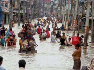A group of people are caught in the flooding in Sirajgong District, Bangladesh on August 1, 2007. Sirajgong District is connected bisected by two rivers, the Jumuna, Brahmaputra, and every day the water level of these rivers has been increasing and has crossed the terrible level reached during the 1988 flood. 38 villages have been inundated with flood water that has affected 200,000 people and left 18 people dead. People have begun to take shelter in the highlands. Getting clean water for drinking and cooking has become almost impossible and people have to depend on dry food. In some remote areas people are not receiving any help, and there are no boats available for transfer to a safe shelter.