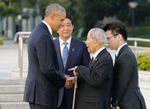epa05331797 US Presdent Barack Obama (L) talks with 91-year-old A-bomb survivor Sunao Tsuboi (2-R) as Japanese Prime Minister Shinzo Abe (2-L) looks on after laying a wreath in front of a cenotaph to offer prayers for victims of the atomic bombing in 1945 at Hiroshima Peace Memorial Park with viewing the Atomic Bomb Dome (Rear) in Hiroshima, western Japan, 27 May 2016. Obama visited Hiroshima for the first time as US President after the atomic bombing of Hiroshima City. Obama visited the city after attending the two-day G7 Ise-Shima Summit talk.  EPA/KIMIMASA MAYAMA / POOL