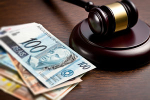 judge gavel with euro bills on wooden background