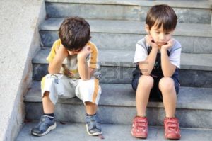 5678776-two-sad-children-on-steps