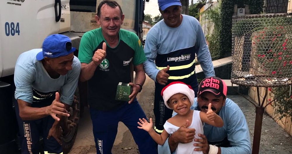 No Acre, menino de 3 anos espera ansioso caminhão do lixo para distribuir panetone a garis