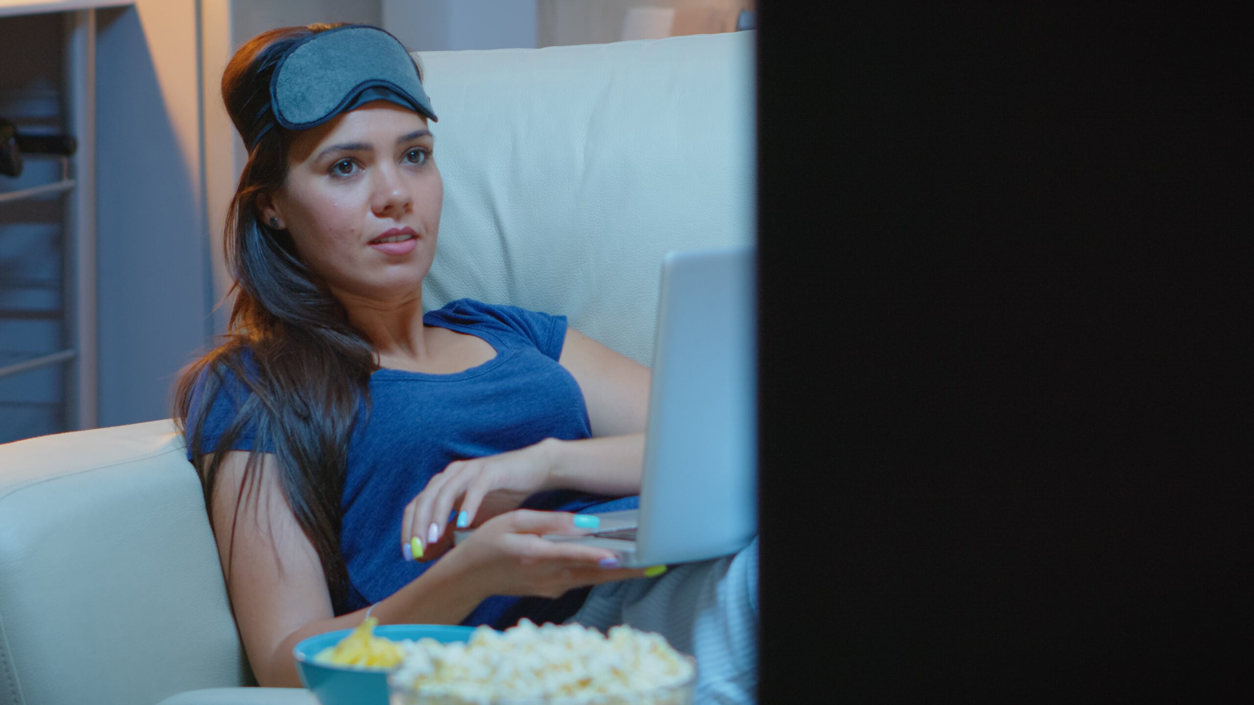 Person With Sleep Mask Using Laptop